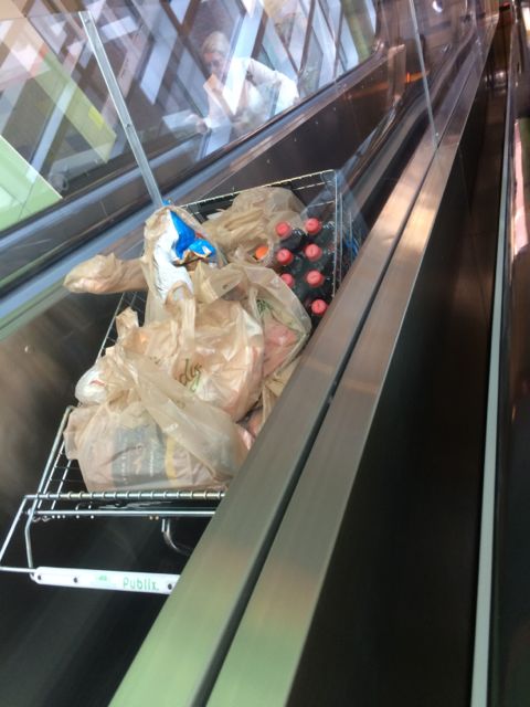 Publix shopping cart going down the escalator