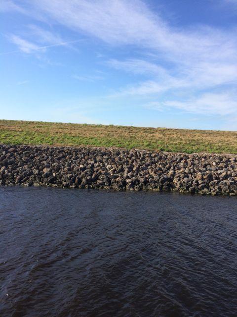 along the side of the waterway