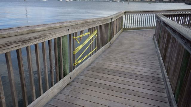 wooden walkway - yellow tape